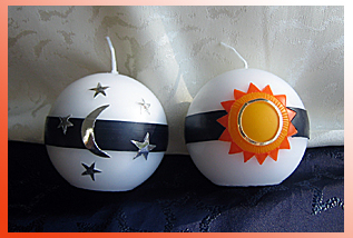 Kugelkerze mit Sonne, Mond und Sternen zur Dekoration